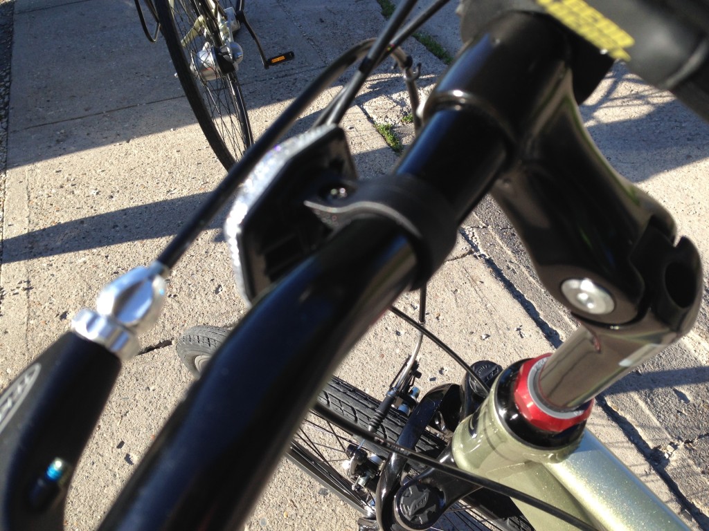 The front reflector is rather cheap, and is actually too small to fit around the handlebar near the center. Instead, it sits off-center and tilted.